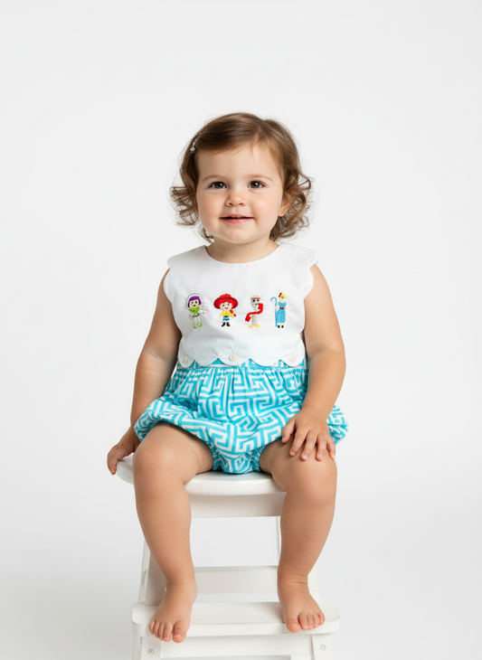 Toddler wearing sleeveless Toy Story Gang Bubble outfit with embroidered astronaut and turquoise patterned shorts.