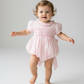 Pink hand smocked cross bubble dress with intricate detailing