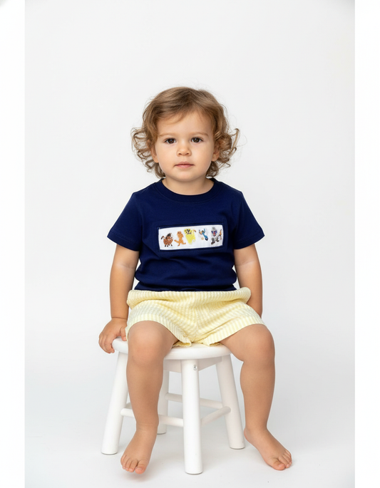 Lion hand smocked boy short set with navy top and yellow striped seersucker bottom featuring animal patterns