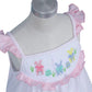 Hand-smocked Easter theme in white with tiny pink dot printed fabric dress